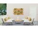 Cozy outdoor patio area with white seating, a wooden accent wall, and lush greenery at 7005 Rosy Sky Ave, Orlando, FL 32829