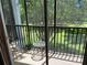 Private balcony with seating, overlooking lush greenery and trees at 409 Lucaya Loop # 409, Davenport, FL 33897