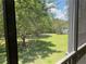 Balcony view showcasing the surrounding trees and grassy area at 409 Lucaya Loop # 409, Davenport, FL 33897