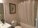 Clean bathroom with a bathtub, toilet, vanity sink, and shower curtain at 409 Lucaya Loop # 409, Davenport, FL 33897
