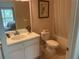 Well-lit bathroom with vanity sink, toilet, and bathtub/shower combination at 409 Lucaya Loop # 409, Davenport, FL 33897