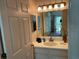 Bright bathroom with a vanity sink, mirror, and view of the bedroom at 409 Lucaya Loop # 409, Davenport, FL 33897