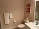 Bathroom featuring a white vanity, toilet, and butterfly-themed decor at 409 Lucaya Loop # 409, Davenport, FL 33897