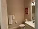 Simple bathroom with white vanity, toilet, and butterfly-themed decor at 409 Lucaya Loop # 409, Davenport, FL 33897