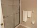 Bathroom with a glass-enclosed shower and tiled walls at 409 Lucaya Loop # 409, Davenport, FL 33897