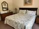 Spacious bedroom with a king-size bed, dresser, mirror, and nightstands at 409 Lucaya Loop # 409, Davenport, FL 33897