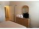 Bedroom with a full-size bed, a wicker dresser with a TV, and a view into an adjacent room at 409 Lucaya Loop # 409, Davenport, FL 33897