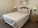 Cozy bedroom with wicker furnishings and matching nightstands at 409 Lucaya Loop # 409, Davenport, FL 33897