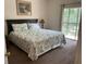 Spacious bedroom with king-size bed, sliding glass door to balcony, and soft carpeting at 409 Lucaya Loop # 409, Davenport, FL 33897