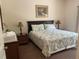 Comfortable bedroom featuring a king-size bed, nightstands, and dresser at 409 Lucaya Loop # 409, Davenport, FL 33897