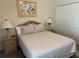 Bedroom with a full-size bed, neutral bedding, nightstands, and closet doors at 409 Lucaya Loop # 409, Davenport, FL 33897