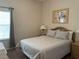 Cozy bedroom with a full-size bed, nightstands, and fish-themed artwork at 409 Lucaya Loop # 409, Davenport, FL 33897