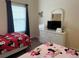 ' bedroom with twin beds, Minnie Mouse theme, and a dresser with a TV at 409 Lucaya Loop # 409, Davenport, FL 33897