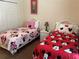' bedroom featuring two twin beds with Minnie Mouse bedding and a dresser at 409 Lucaya Loop # 409, Davenport, FL 33897