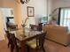 Open-concept dining area and living room with glass-top table and wicker chairs at 409 Lucaya Loop # 409, Davenport, FL 33897