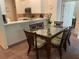 Dining area with glass-top table, wicker chairs, and view of the kitchen at 409 Lucaya Loop # 409, Davenport, FL 33897
