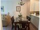 Dining area with glass-top table, wicker chairs, and view of living area at 409 Lucaya Loop # 409, Davenport, FL 33897