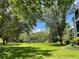Lush green space with mature trees and glimpses of the condo buildings at 409 Lucaya Loop # 409, Davenport, FL 33897