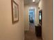 Hallway with carpeted flooring and a decorative wicker console table at 409 Lucaya Loop # 409, Davenport, FL 33897