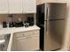 Kitchen with white cabinets, stainless steel appliances, and included small appliances at 409 Lucaya Loop # 409, Davenport, FL 33897
