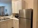 Kitchen corner showcasing stainless steel refrigerator and white cabinetry at 409 Lucaya Loop # 409, Davenport, FL 33897