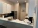 Kitchen with white cabinets, black appliances, and white countertops at 409 Lucaya Loop # 409, Davenport, FL 33897