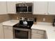 Kitchen featuring stainless steel appliances, white cabinets, and a tiled backsplash at 409 Lucaya Loop # 409, Davenport, FL 33897