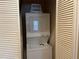 Compact laundry room with a stacked washer and dryer unit at 409 Lucaya Loop # 409, Davenport, FL 33897