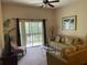 Inviting living room with comfortable seating, sliding door to balcony, and neutral decor at 409 Lucaya Loop # 409, Davenport, FL 33897