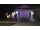 Two-story home with festive lights, two-car garage, and brick paver driveway at 1263 Verdant Glade Pl, Winter Park, FL 32792
