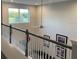 Open loft area with a ceiling fan and large window overlooking the living room at 1263 Verdant Glade Pl, Winter Park, FL 32792