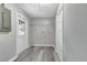 Bright laundry room with vinyl flooring, built-in shelving, and exterior access at 1802 Jupiter St, Lakeland, FL 33801