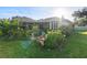 Landscaped backyard with lush greenery and a brick planter at 1694 Town Park Dr, Port Orange, FL 32129