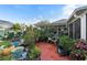 Landscaped backyard with various plants and terracotta patio at 1694 Town Park Dr, Port Orange, FL 32129