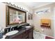 Double vanity bathroom with dark wood cabinets and a large mirror at 1694 Town Park Dr, Port Orange, FL 32129