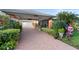 Brick driveway, lush landscaping, and decorative holiday figures at 1694 Town Park Dr, Port Orange, FL 32129