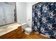 Clean bathroom with shower/tub combo, vanity, and floral shower curtain at 4915 Mount Pleasant Rd, Groveland, FL 34736