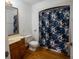 Clean bathroom with shower/tub combo, vanity, and floral shower curtain at 4915 Mount Pleasant Rd, Groveland, FL 34736