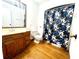 Clean bathroom with wood vanity and floral shower curtain at 4915 Mount Pleasant Rd, Groveland, FL 34736