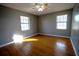 Bedroom with gray walls, wood floors, and ceiling fan at 4915 Mount Pleasant Rd, Groveland, FL 34736