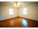 Bright bedroom with wood floors and ceiling fan at 4915 Mount Pleasant Rd, Groveland, FL 34736
