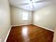 Spacious bedroom with wood floors and ceiling fan at 4915 Mount Pleasant Rd, Groveland, FL 34736