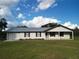 House exterior showcasing a ranch-style home with a metal roof and a covered porch at 4915 Mount Pleasant Rd, Groveland, FL 34736