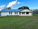 Ranch style home features metal roof, covered porch, and large yard at 4915 Mount Pleasant Rd, Groveland, FL 34736