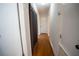 Long hallway with wood flooring and neutral walls at 4915 Mount Pleasant Rd, Groveland, FL 34736