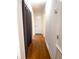 Long hallway with hardwood floors and access to bedrooms at 4915 Mount Pleasant Rd, Groveland, FL 34736
