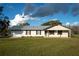 House exterior with attached garage and front yard at 4915 Mount Pleasant Rd, Groveland, FL 34736