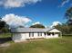 Single story house with metal roof and landscaping at 4915 Mount Pleasant Rd, Groveland, FL 34736