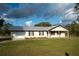 Front view of a single-story house with a garage and large grassy yard at 4915 Mount Pleasant Rd, Groveland, FL 34736