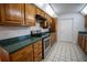 Kitchen with wood cabinets, granite counters, and stainless steel appliances at 4915 Mount Pleasant Rd, Groveland, FL 34736